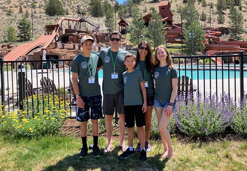 Korolyk family in front of water slides at flok Family Camp West